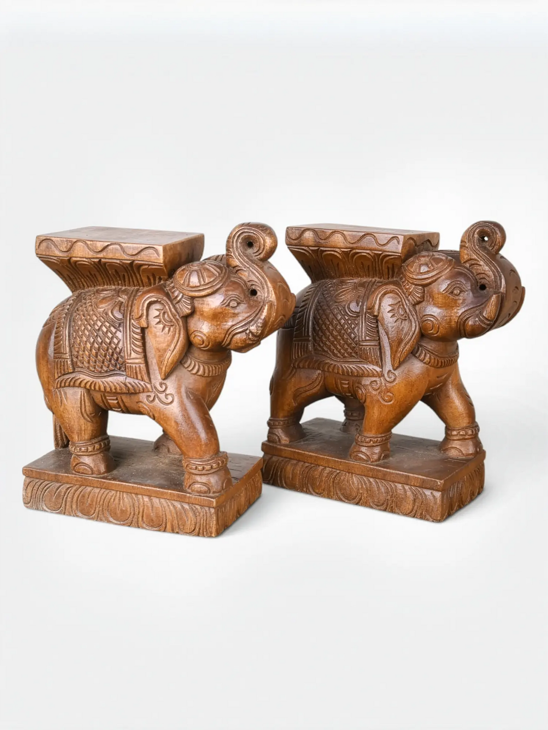 Wooden elephant sculptures used as shelf supports