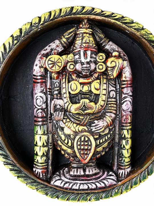 Wooden Balaji wall panel surrounded by eight Lakshmi forms.
