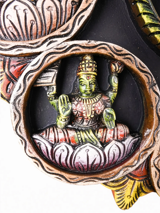 Traditional Indian wooden wall carving with Balaji centerpiece.