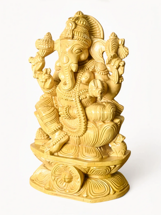 Handcrafted wooden Ganesha idol with intricate traditional South Indian carving.
