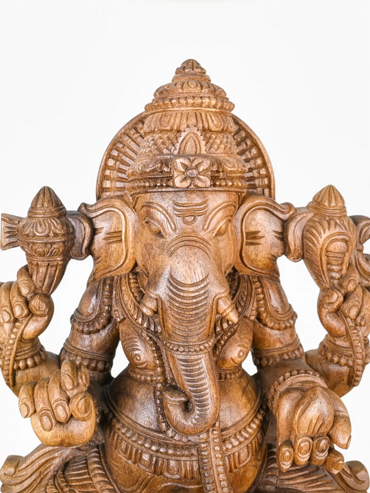 Elegant handcrafted wooden Ganesh sculpture with intricate temple-style detailing.
