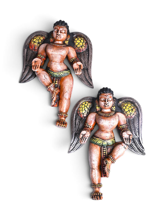 Wooden angel sculpture with detailed wings and ornaments