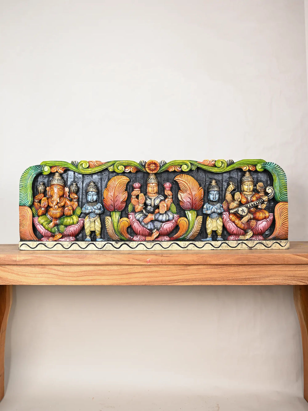 Wooden panel of Ganesha, Lakshmi, and Saraswati