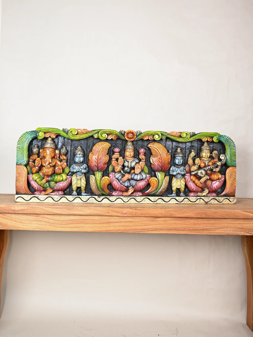 Wooden panel of Ganesha, Lakshmi, and Saraswati