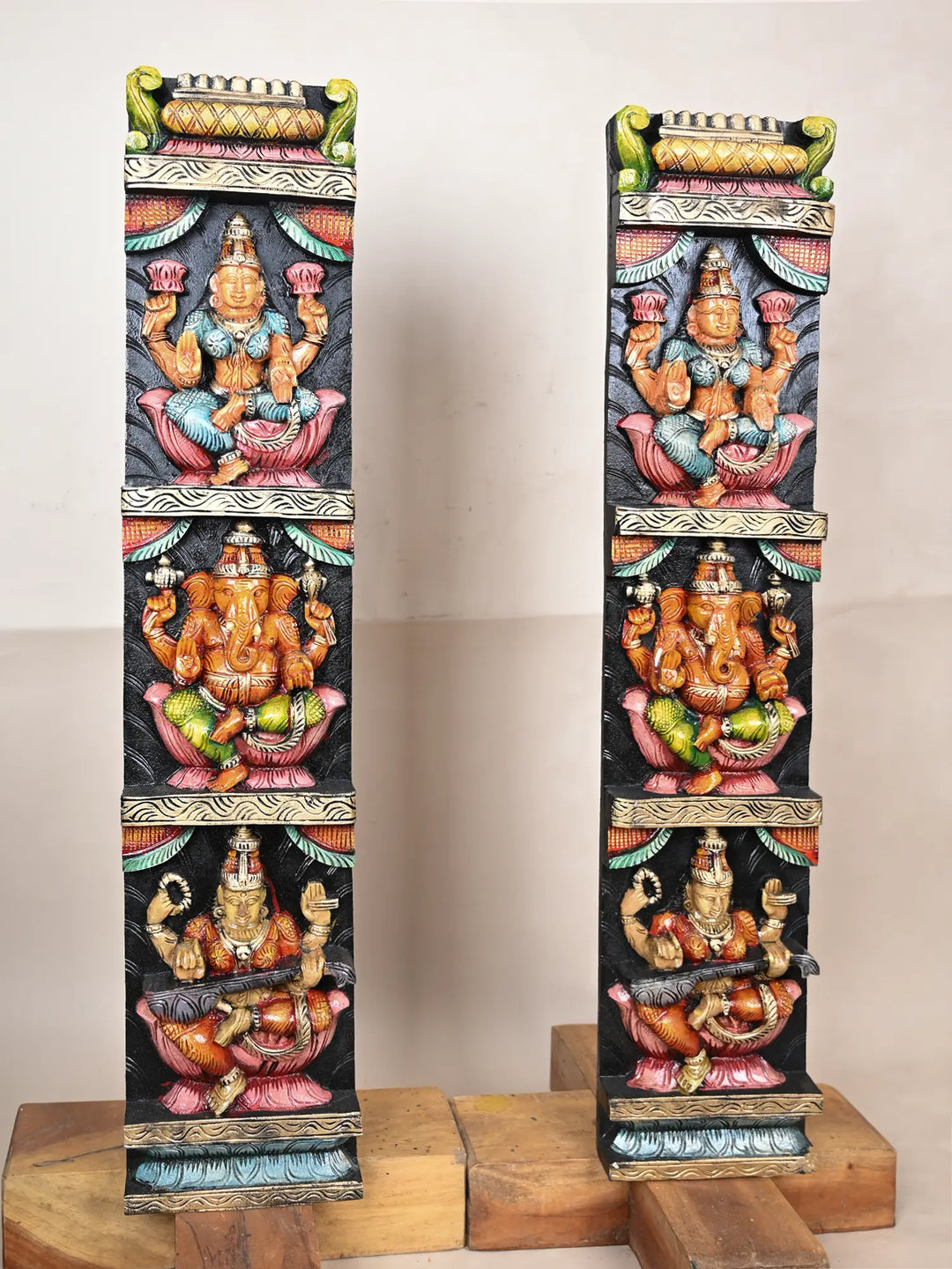 Wooden panel of Ganesh, Lakshmi, and Saraswathi 