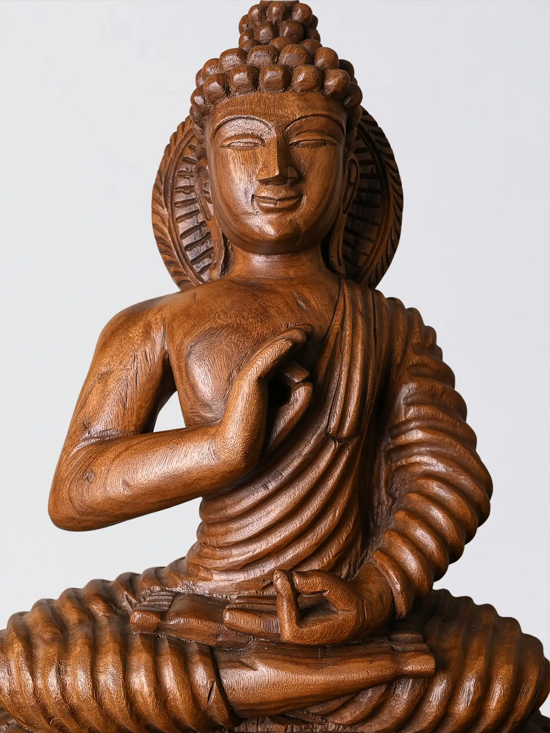 Handcrafted wooden Buddha idol close up carving