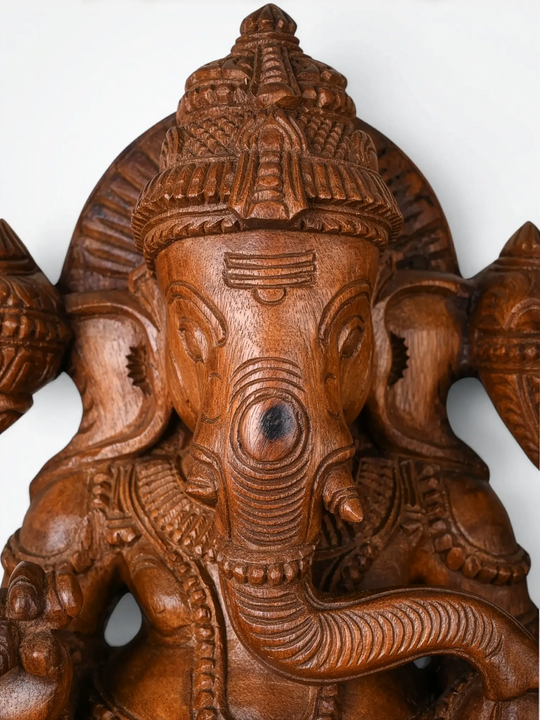 Elegant wooden Ganesha idol seated on lotus pedestal for spiritual home decor