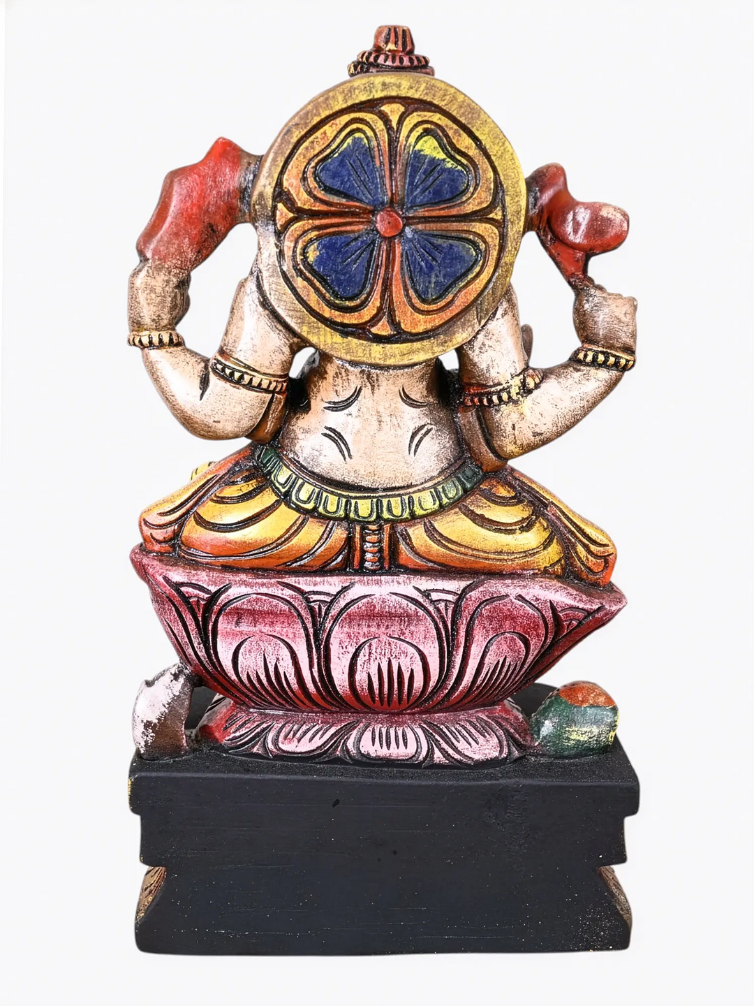 Hand-painted wooden Lord Ganesha idol seated on a pink lotus with vibrant traditional detailing.