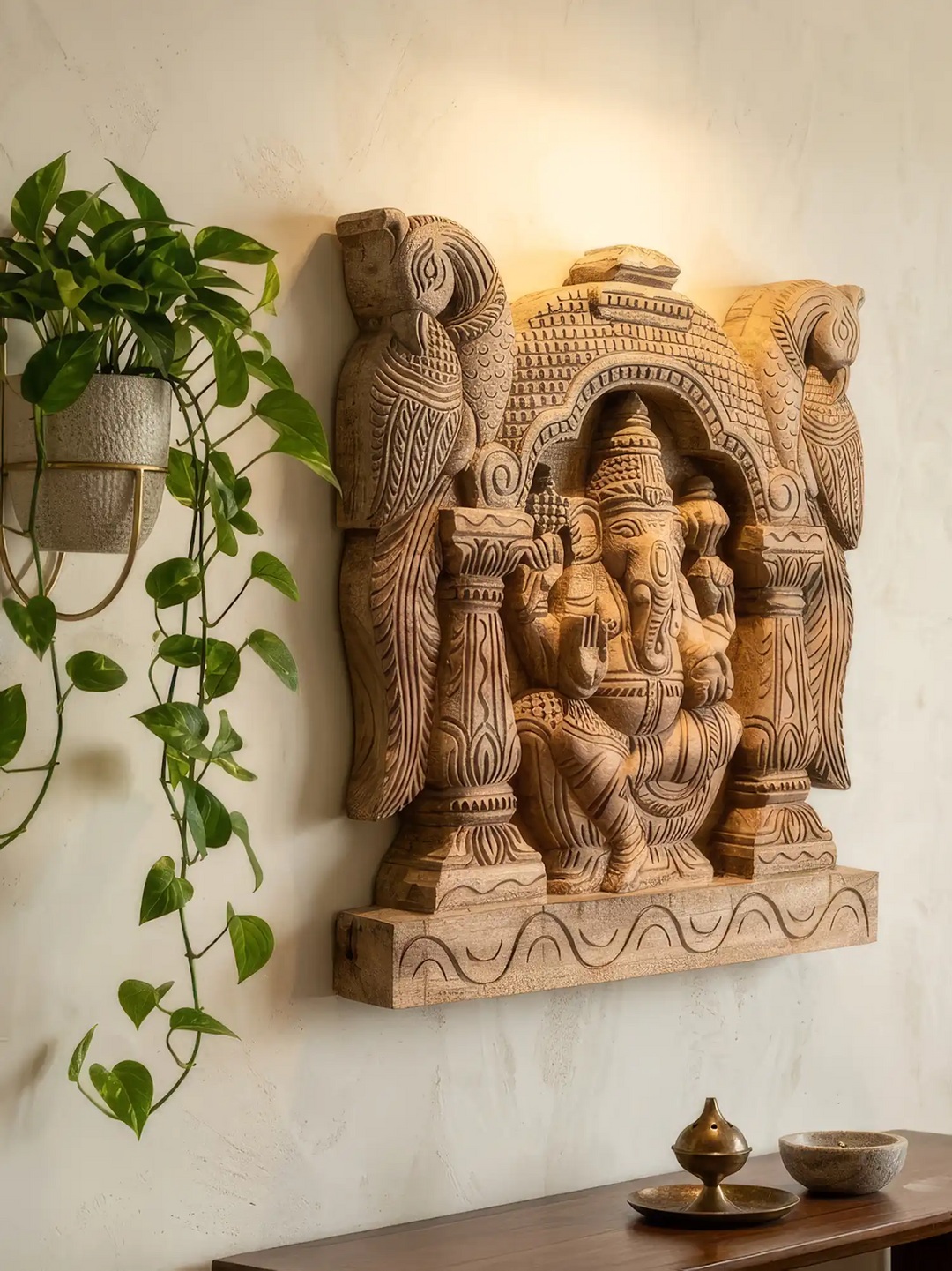 Wooden Ganesha religious wall panel showcasing fine artisan temple carving details.