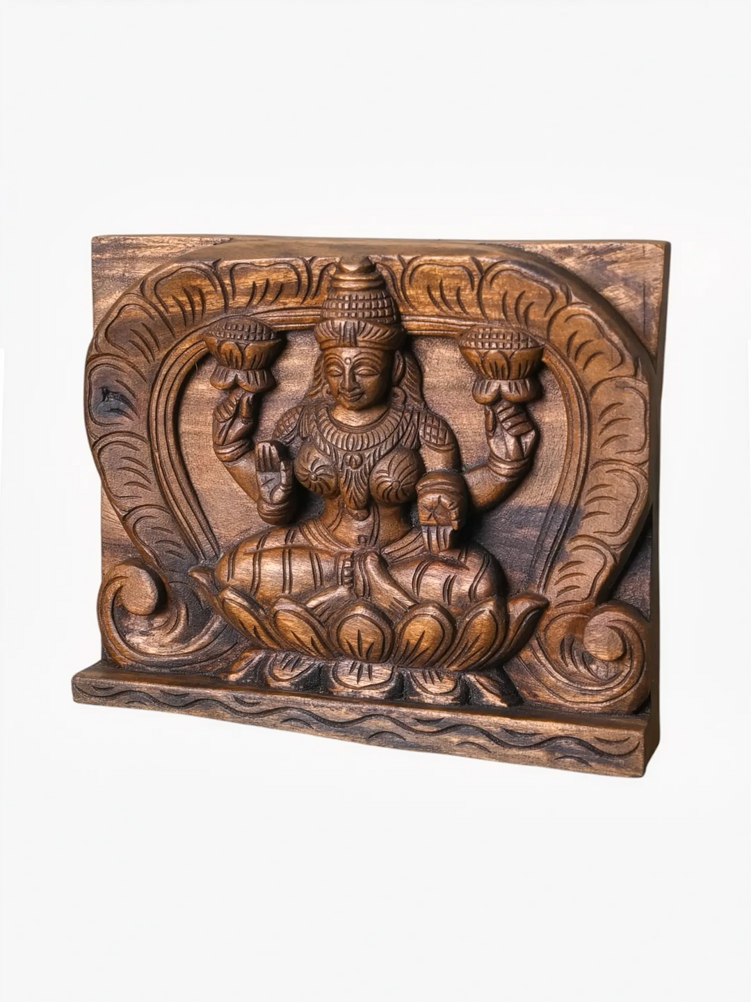Handcrafted wooden Lakshmi wall panel with lotus carving.