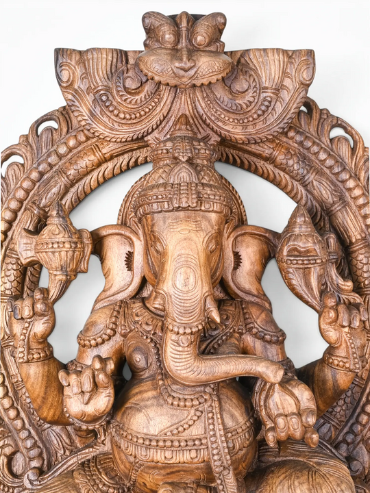 Wooden Hindu god sculpture with decorative temple-style Prabhavali.