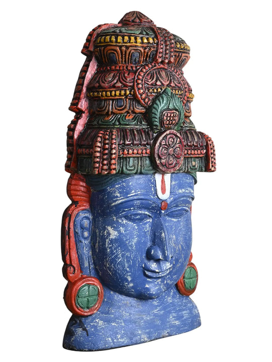 Side profile view of a wooden Lord Vishnu face mask