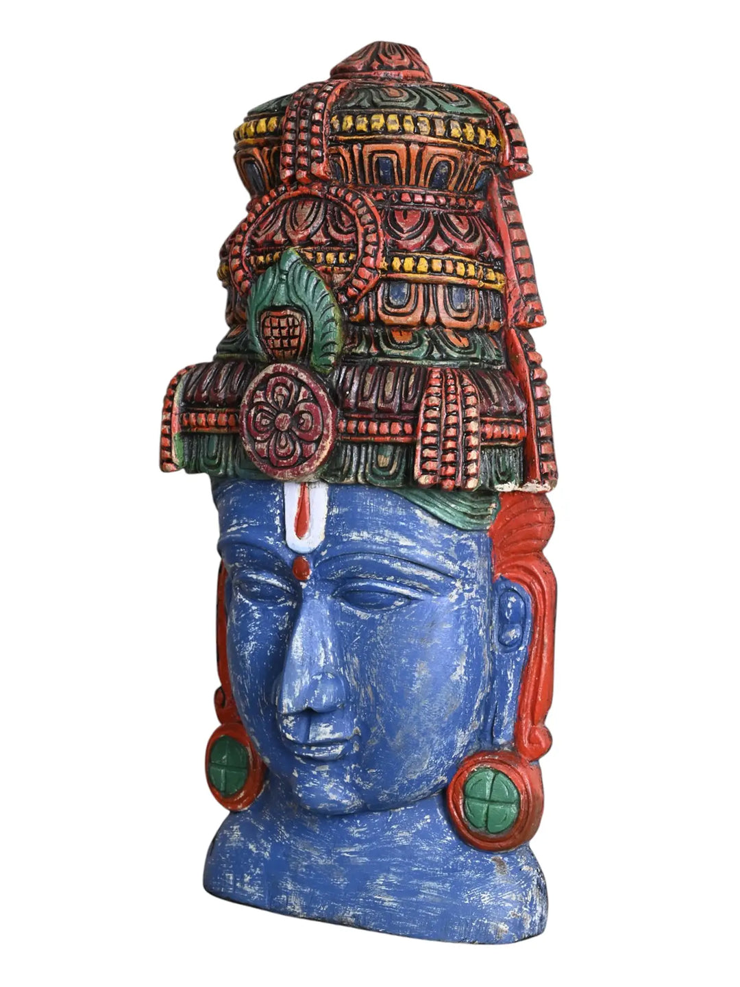 Side profile view of a wooden Lord Vishnu face mask