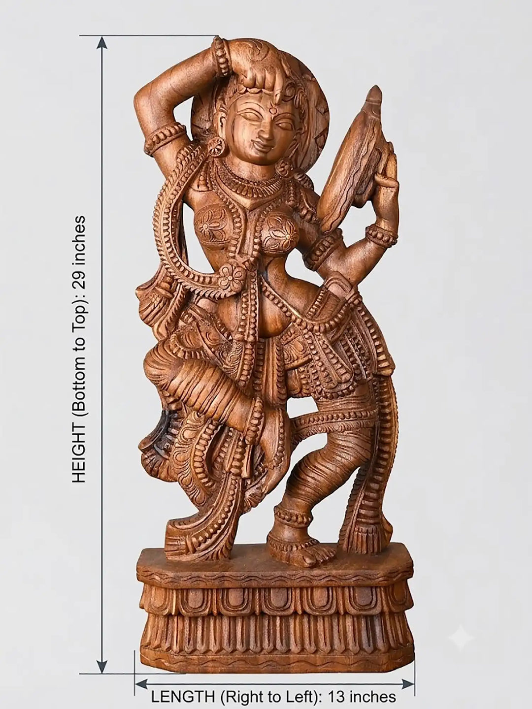 Detailed hand carved wooden lady looking at mirror