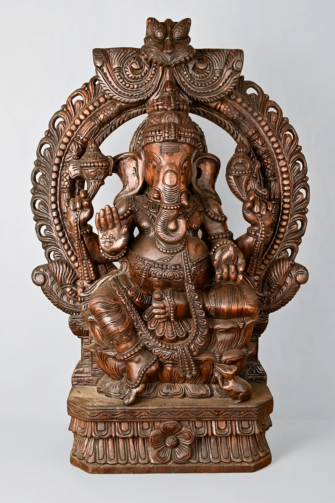 Dark brown wooden Ganesha idol with Prabhavali