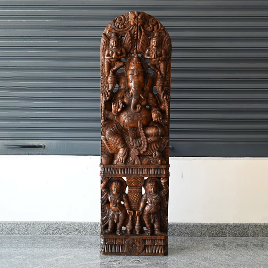 Wooden Ganesha statue with intricate temple-style carving