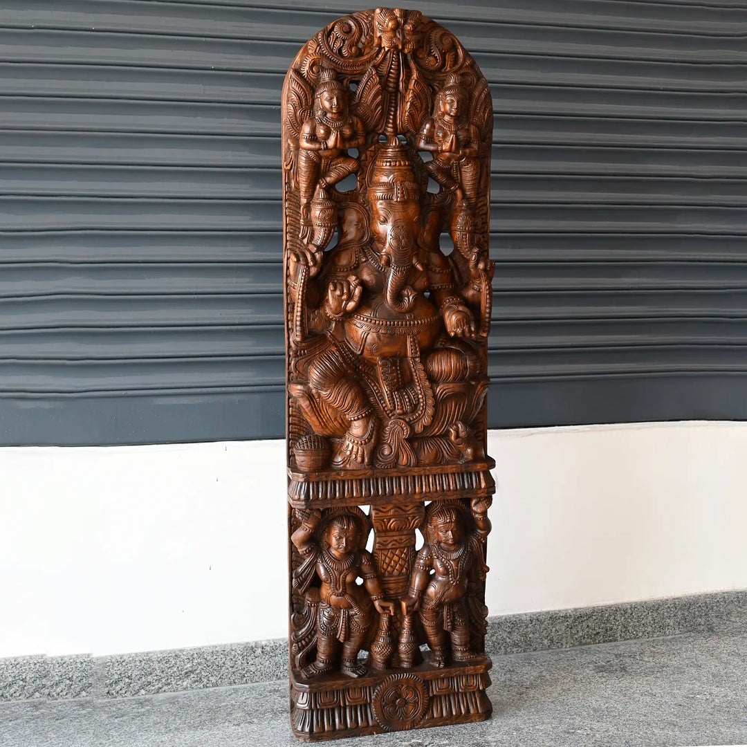 Wooden Ganesha statue with intricate temple-style carving