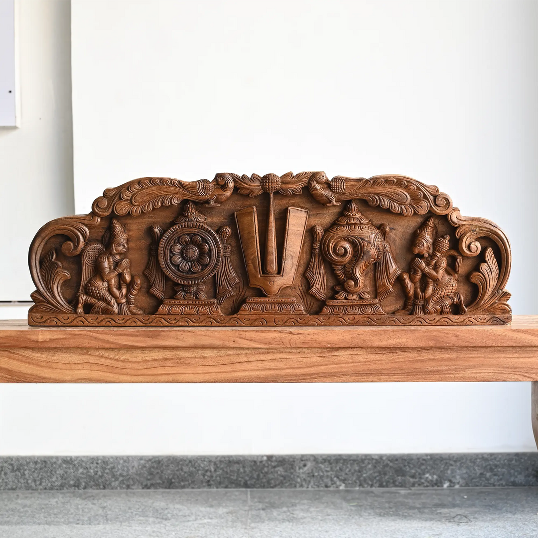 Traditional wooden panel featuring sacred symbols of Lord Vishnu