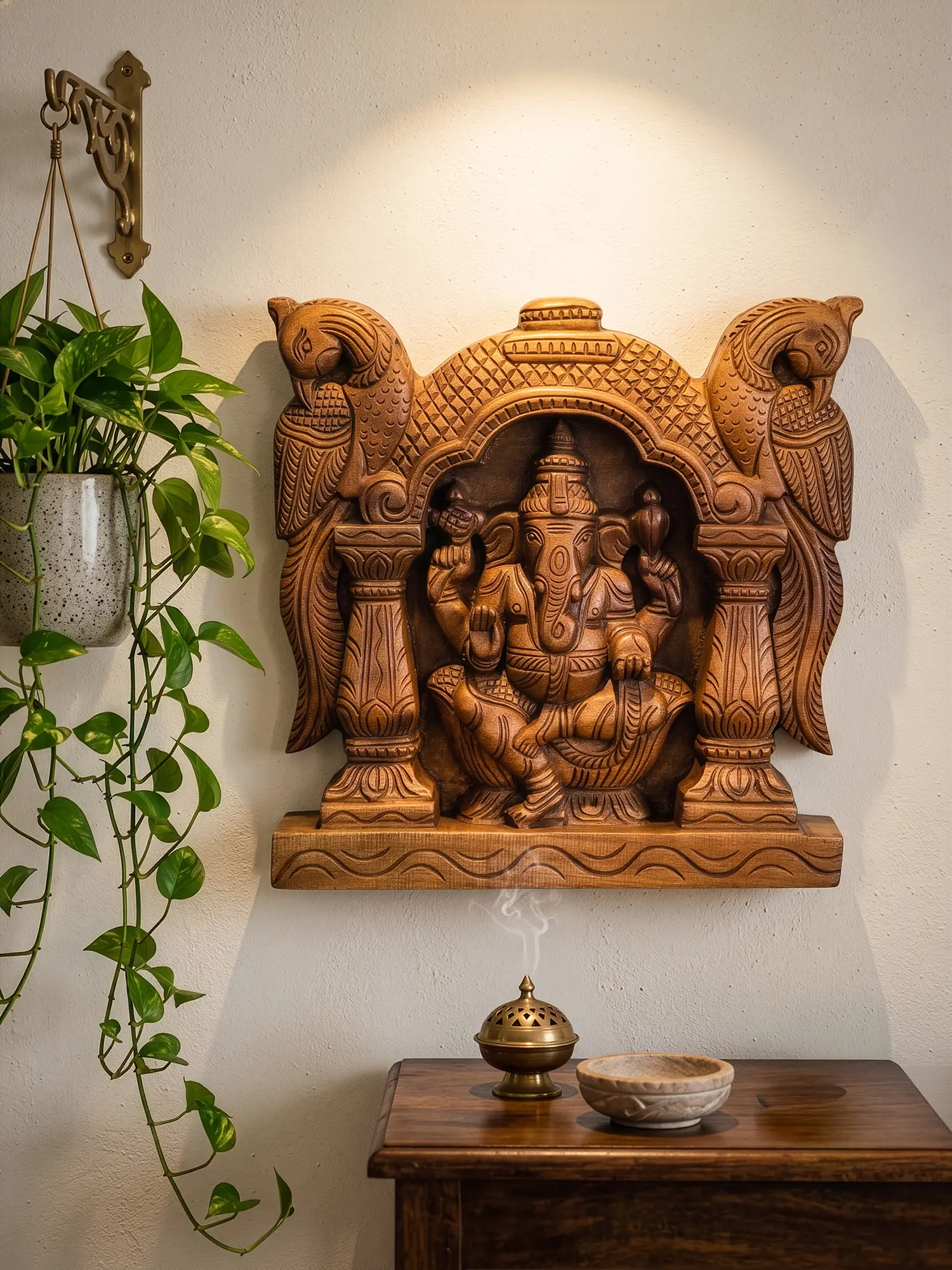 Wooden Ganesha religious wall panel showcasing fine artisan temple carving details.