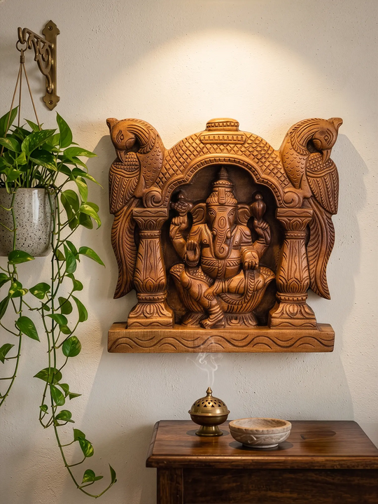 Wooden Ganesha religious wall panel showcasing fine artisan temple carving details.