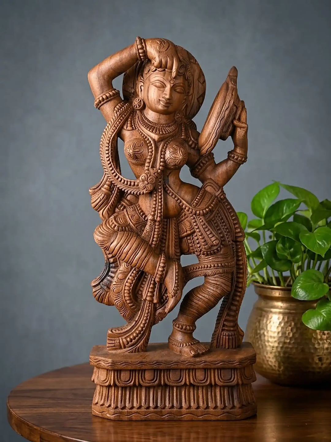 Detailed wooden Apsara sculpture with mirror